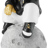 BRUBAKER Figurine Astronaut Sits on The Moon in a Cool Pose - 9.5 Inch Spaceman Space Decor Figure with Chromed Helmet and Black Hoodie - Hand Painted - Gold, Black and White