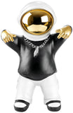 BRUBAKER Figurine Astronaut with Black Hoodie in Cool Pose - 8.3 Inch Spaceman Space Decor Figure with Chrome Plated Helmet and Silver Chain - Hand Painted - Gold, Black and White